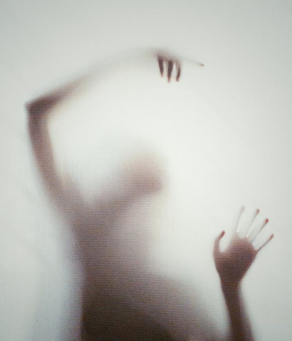 Abstract silhouette of a person in a slow, deliberate movement.